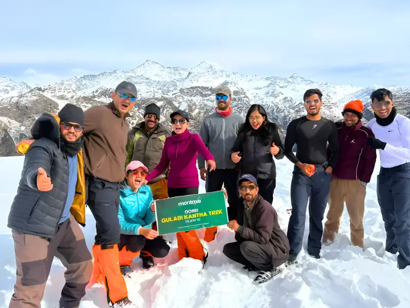 Best Winter Treks In Uttarakhand 6 Trekkers celebrating at the summit during Gulabi Kantha winter trek in Uttarakhand